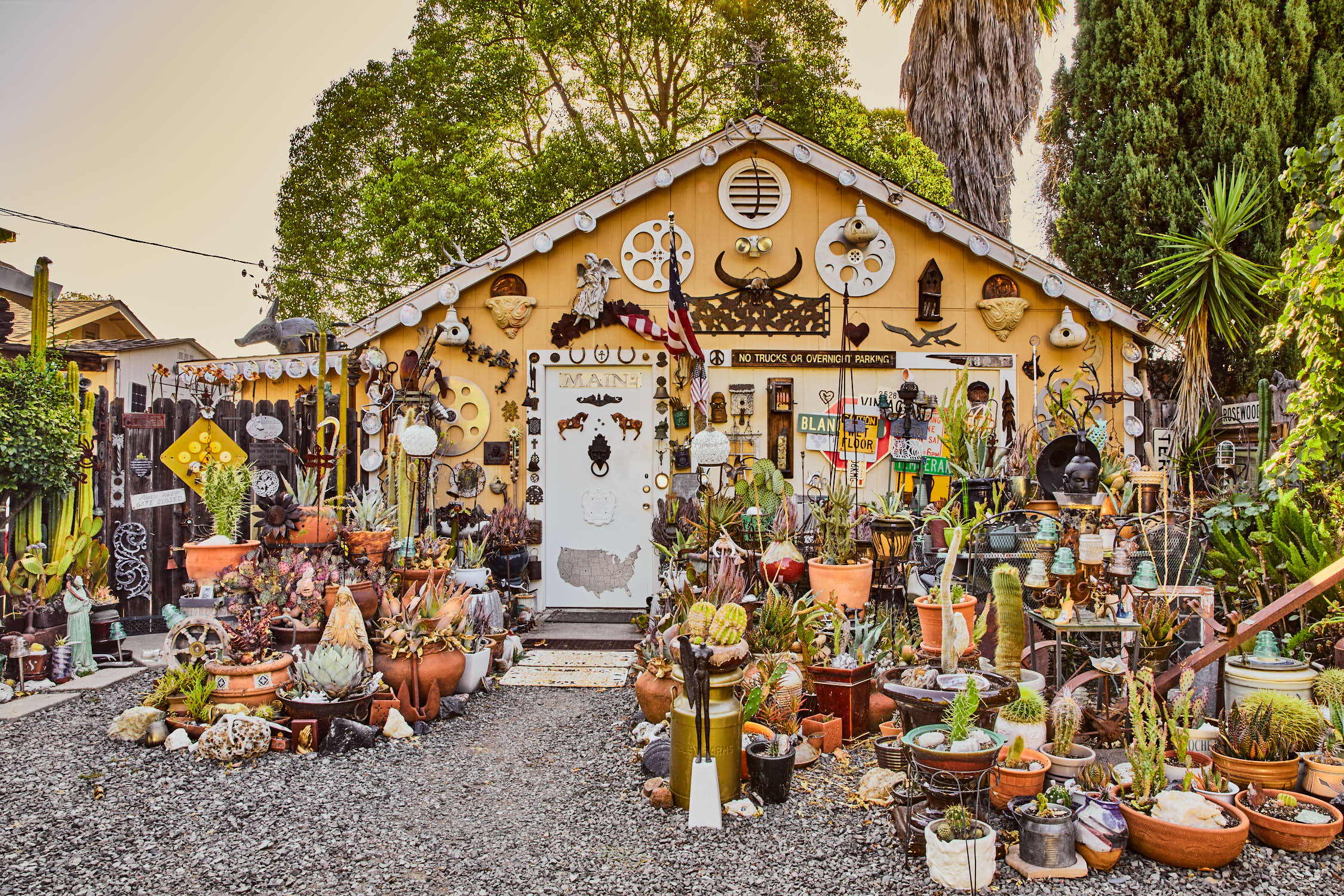 The succulent secret garden surrounds a small building that is an art studio interspersed with art made from junk.